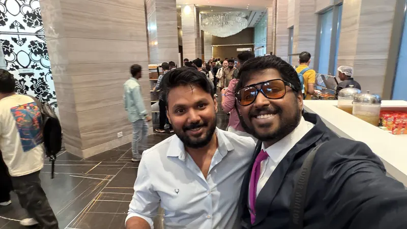 Shivanath Devinarayanan with a fellow attendee by the food counter