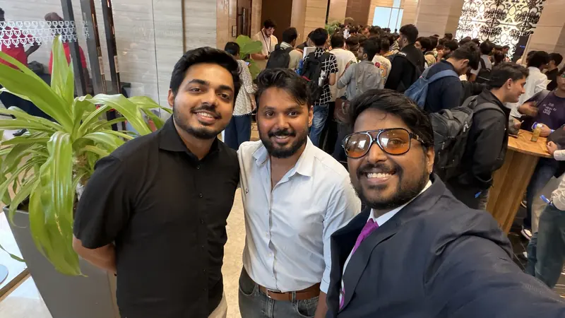 Shivanath Devinarayanan with two fellow attendees in the crowded venue lobby