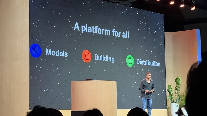OpenAI speaker on stage in front of a slide reading A platform for all: Models, Building, Distribution